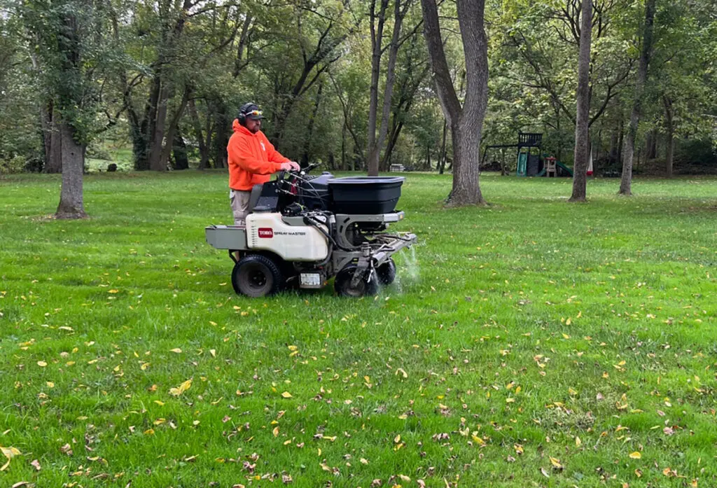 JHL Turf Pros team member doing a lawn application